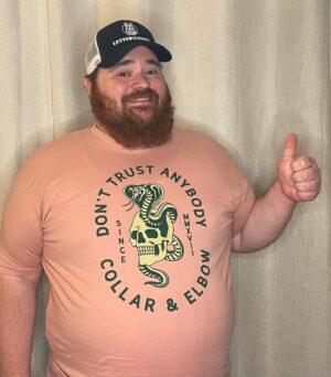 K. Trevor Wilson Instagram - Here is my other D.T.A. shirt from @collarxelbow. It’s a great shirt but I don’t think the colour is right for me. I wear this when I want to pretend I have a chest tattoo but no bellybutton or nipples