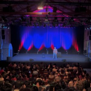 Kanan Gill Instagram - 21 shows, 19 cities, 3 illnesses, 2kg. Touring (parts of) Europe was immensely rewarding. Thank you for coming.
 . . .
“Do you ever worry about becoming a self-parody?”

The clump of moss on the rock face frowned for a minute. “In what sense? It’s your move, by the way”, it said indicating the chessboard stapled to the overhang.

“In the sense of becoming an employee of a previous version of yourself that was free.”

A passing eagle coughed pointedly at how loud we were being. I pressed myself closer to the rock face.

“Nope” said the moss, quite loudly, ignoring my shushing. “Being moss is embracing the plurality of existence, in the sense that there is no singular moss, there are outlines until there is mossing, and that space in which there is moss-ness, is moss. Dude seriously it’s your move.”

The chessboard has no pieces, since we were high up an infinite rock face and it was stapled sideways.

“So you’re talking about being as a process—“

“—A mossess”, corrected the moss.

“But you can still take a sliding window of the continuous change of self and call it who you used to be—“

“—what is this really about?” Interrupted the moss, finally lowering it voice and putting away its Nokia Ngage.

“That I’m worried lasting growth is impossible and decay is inevitable. I keep climbing from epiphany to epiphany, never further off the ground; fingers clasped around realisation, finding the odd abscess of wisdom to rest in. I’ve moved so much, but I’m still here.”

A shower of embarrassed rocks fell past from heights unknown to depths infinite, mumbling apologies. I wept bitterly.

“Ah silly” said the moss ruffling my hair. “There’s nowhere to reach. The path isn’t the climb, it’s the climber. You don’t scale these heights. You hang on till you fall off one day.”

A shuddering relief left my lips. “That’s it?”

“That’s it, smiled the moss. “Now, do you want to play your turn?”

“Sure. Knight to E3!”

“Dude this is Ludo.”