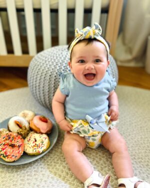 Katie Carpenter Instagram - 6 months 🍩 1/2way to one! ✨I thought this day was always so far away, but now here we are (3 days late lol). 

Our baby girl is the best little cutie pie and brings so much joy to our lives. 

She loves:
🍩 people (She’s never met a stranger)! 🥰
🍩 tummy sleeping 😴
🍩 watching her furry brothers and sister 🐶🐾
🍩 lights & fans! 💡
🍩 peas 🫛
🍩 grabbing our arms during diaper changes, pulling it to her mouth, and giggling when we pull it back 😂
🍩 kicking her chunky little legs 🥖

Cannot believe she’s been in our lives for half a year. It’s been so incredible seeing her grow and change!! 🫶🏻