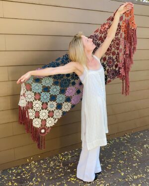 Kirsten Nelson Instagram - It is finished - with fringe!! My interpretation of the #purlsoho #cielitolindowrap!! These beautiful colors were leftovers from a previous knitting project and I was looking for something to use it on for years. My mood (and really how much yarn I had on hand…) guided my eventual schematic, flowing and ebbing, and truly what just felt good. Incredibly happy I found this pattern. 🧶💃#crochet #purlsohobusyhands