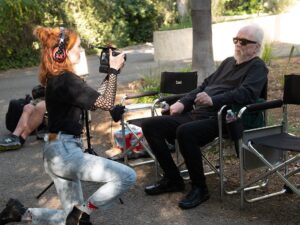 Kyra Elise Gardner Instagram - A very happy birthday to the great @johncarpenterofficial 🎉 Not pictured is me dropping his microphone before handing it to him because I was so nervous 😬 Very grateful to have been a small piece on @studio666movie in so many ways 🖤 📸: @ndrewstuart #studio666 #johncarpenter #davegrohl
