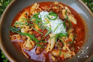 Lawrence Duran Instagram - Zuppa di Lasagne
(Lasagna Soup)
Soup season is upon us 🍂 
Give this comforting classic recipe a go and let me know what you think

1 lbs campanelle pasta 
1 lbs ground beef 
1 lbs Italian sausage 
1- medium onion
6- cloves of garlic
2 Tbsp tomato paste 
3- vine tomatoes 
1- 28 oz can crushed tomatoes 
64 oz chicken stock
1 tsp fennel 
2 tsp Italian seasoning 
2 tsp spicy Italian 
2 tsp sugar 
1 bunch basil
Ricotta 
Fresh parm

Mix ricotta and minced basil and set aside 
Dice whole onion and sweat in olive oil until translucent
Mince garlic and add in with ground beef and sausage and cook 7-10 minutes
Add tomato paste, Italian seasoning, fennel and spicy Italian and cook for 3 minutes 
Toss in diced tomatoes, can of crushed tomatoes, chicken stock, rind of parm and sugar. 
Bring to a boil then reduce heat, cover pot and simmer for 20-30 minutes.
In a separate pot bring water to boil then add in pasta. Cook pasta until al-dente then add pasta and 4oz of pasta water to the soup
Cook soup an additional 5-7 minutes then serve 
Top with a dollop of basil ricotta, fresh grated parm and drizzle with olive oil
ENJOY!!

#lasagna #soup #comfortfood #italian #fall #privatechef #WahlbergChef #family #blessed