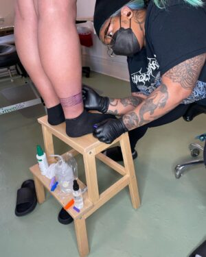 Lindsay Philomene Instagram - I worked on this very special collaboration with my mentor @phylotattoos this weekend. She’s an expert in straight-line work, so when I received this client’s request, I reached out (with the client’s consent of course) to see if she would give me some guidance. 

It ended up being a remarkable day of tattooing for all of us. We shared snacks, stories, Phylo shared some of her technical expertise with me, and we put our brains together for the trickiest parts (putting that stencil on, wowza!). Any artist will tell you that tattooing is a practice of life-long learning. In an era of social media influencers & tattoo celebrities who only show images of tattoo “perfection”, I think it’s important for us as artists to demonstrate that we are human: always learning, and that none of us do it alone. Also, in my own practice, I understand how vital the experience of being tattooed is for my clients, and I’m really grateful for the beautiful container that we were able to create together 🩵 

Thanks again to Melissa & Phylo, & I look forward to finishing up this weekend! 

Also the 4th slide is dedicated to all the body-workers who treat tattoo artists. Now you know why our bodies are so broken lol 😬
Done @catalpastudio 
.
.
.
.
.
.
.
.
.
.
.
.
#tattoocollaboration #montrealtattoo #melanintattoos #finelinework #phylotattoos #redink #redtattoo #queertattooer #queer #montrealtattooers #nonbinarytattooartist
