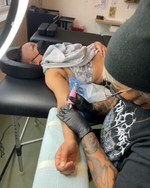Lindsay Philomene Instagram - I worked on this very special collaboration with my mentor @phylotattoos this weekend. She’s an expert in straight-line work, so when I received this client’s request, I reached out (with the client’s consent of course) to see if she would give me some guidance. 

It ended up being a remarkable day of tattooing for all of us. We shared snacks, stories, Phylo shared some of her technical expertise with me, and we put our brains together for the trickiest parts (putting that stencil on, wowza!). Any artist will tell you that tattooing is a practice of life-long learning. In an era of social media influencers & tattoo celebrities who only show images of tattoo “perfection”, I think it’s important for us as artists to demonstrate that we are human: always learning, and that none of us do it alone. Also, in my own practice, I understand how vital the experience of being tattooed is for my clients, and I’m really grateful for the beautiful container that we were able to create together 🩵 

Thanks again to Melissa & Phylo, & I look forward to finishing up this weekend! 

Also the 4th slide is dedicated to all the body-workers who treat tattoo artists. Now you know why our bodies are so broken lol 😬
Done @catalpastudio 
.
.
.
.
.
.
.
.
.
.
.
.
#tattoocollaboration #montrealtattoo #melanintattoos #finelinework #phylotattoos #redink #redtattoo #queertattooer #queer #montrealtattooers #nonbinarytattooartist