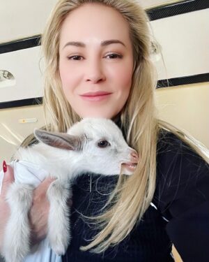 Louise Linton Instagram - Sunshine is a baby goat born with a severe cleft palate. 
This birth defect needs multiple surgeries by innovative surgeons to be repaired...the thing is- many hospitals that treat goats do not do these surgeries. Viva rescue has a surgeon and a program set up specifically for such extreme cases. 

Sunshine was all the way in New York and the Viva sanctuary is in CA so when they needed to find a way to transport her, I offered to help. I never knew the first time I would change a diaper would be for a goat! 

This morning sunshine got the first of many procedures as she got a tube placed surgically so the Viva team can feed her bypassing the cleft palate until she is strong enough for her series of reconstructive surgeries. 

Please remember that while baby goats are cute, buying them Before they are weaned from their mothers is WRONG. Visit respected rescue sanctuaries instead. 🐐💗🙌🏼☀️