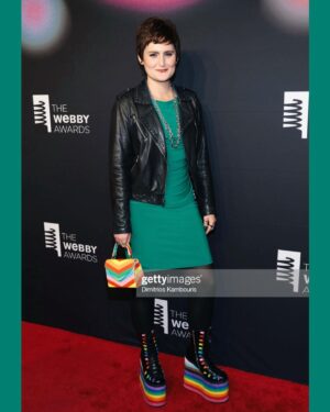 Mary Chieffo Instagram - making the @thewebbyawards red carpet a little more green and a little more gay 

🖤🌈✨

fun fact: this is the dress I wore for my Juilliard audition & the emerald ring on my index finger was my grandma Libba’s! 

#webbys #webbyawardwinner #redcarpet #diversityequityinclusion #creator #iagothegreeneyedmonster #ar 
#upcycledfashion #rainbowboots 

hair: @arlenjeremy @killerbeauty_by_ligia @brindleyhairstudio