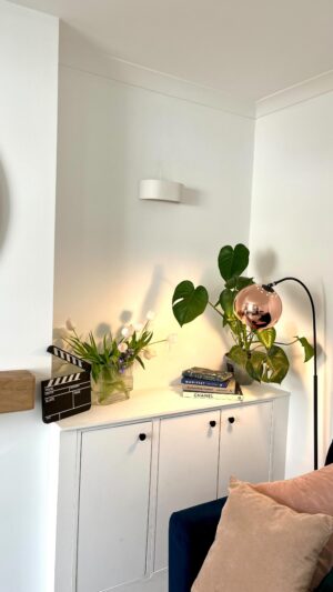Megan Taylor Instagram - Our living room before and after ✨ 
I think we’ve completed this room!!
There are of course some tiny bits to do but aesthetically we’re done!

What we’ve done:
• Plastered the artex ceiling
• Removed the wood chip paper
• Plastered the walls
• Painted the walls
• Plastered the chimney breast
• Installed a faux cast iron rad
• Dad built us the recessed cupboards
• New sconces
• New flooring

What do you think?

#beforeabdafter #livingroomrenovation #victorianterrace  #victorianhouse #victorianhouserenovation
