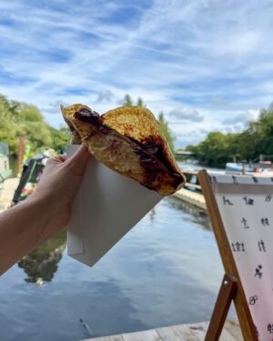 Megan Taylor Instagram - We’ve had such a lovely Friday afternoon off work. We drove to pick mum up and whisked her off to visit @d.oyly.s for a crepe 🥞.

It was such a lovely place to visit. 
You can take dogs too!

Albie and I had TWO ‘Buena Sarah’s’ which is the chocolate praline crepe. It was my favourite chocolate pancake I have EVER eaten in my whole life- seriously!! There were chunks of @kinderbueno_official in it!!!!!!! 👌🏼 (my picture of it is not representative of how fab it was 😂 

Originally we couldn’t find a table because it was so busy so we sat on the deck (with a couple of deckchairs) with Albie’s toys spread out on the floor. When we got a table we actually let someone else have it because sitting around by the river edge was perfect.
I have to say it felt a little bit anxious making with Albie by the river but where we were it wasn’t deep so it would have been fine if he had decided to jump in 😂.

They’re open until 8pm everyday now and serve cocktails so a chilled date night with Liam (when I’m back drinking 🍸) there would be magical and as if we’re on holiday 🏖️ 

Highly recommend going, it’s a lovely gem of a spot xx

•
•
•
#doylyisland #weybridgecafe #surreyhotspot where to go in surrey | doylys island #gilbertandsullivan