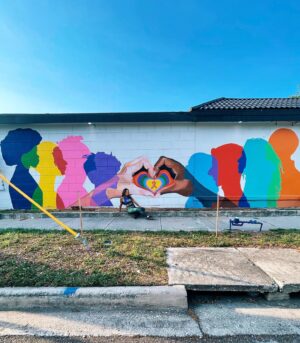 Melanie Posner Instagram - When looking at this mural you wouldn’t know that it’s unfinished. It was supposed to have a tagline at the top that read “It takes every community,” with a QR code that led to The Ryan White Care Council’s website. This mural was fully funded by this organization to raise awareness and beautify the community. Unfortunately the building owner of where this is located changed his mind mid project (because he donated his wall to us) and I had to stop painting. We sadly had to leave this project unfinished for 6 months. All this time- behind the scenes- despite getting threatened for trespassing or defacing property if I finished the mural, I fought so it could be complete. The message in my art is so important to me. I wanted to portray diversity, inclusivity, and togetherness. With the state that Florida is in right now we need that more than ever. So after blood, sweat, and tears I’m glad I could finally come back and leave the neighborhood with this. Always fight for what you believe in 🫶🏼It’s located on the side of Nicko’s Pizza in DTSP ❤️ Please note that the pizza shop was in equal outrage as me, they just rent from the building owner, and you should go support them. 
.
.
.
.
.

#DTSP #stpetemurals #stpeteart #muralartist #lgbtqart #womenwhopaint #stpetersburgfl
