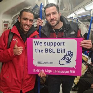 Michael Parr Instagram - Met some students and teachers from @oaklodgeschool on the tube and they had been protesting at Westminster to get the BSL (British sign language) act bill passed. 

The BSL act bill would allow British Sign Language to be recognised as an official language. Talking to the teachers, they explained this would allow many Deaf BSL users access to public life, basic rights such as having BSL interpreters at medical appointments, having access to government broadcast and recognition for their language and culture. The kids I met were part of history and want to see BSL on the curriculum so kids across the UK can learn their amazing language. 

Thankfully the bill did pass however there is still a way to go before it can be legally recognised. The next reading is on 18th March 2022 and if that passes then it will become law. This is a step in the right direction for the Deaf community but especially for these kids from @oaklodgeschool. 

Find out more how you can support this campaign here @bslactnowcampaign 

#bslactnow

Nice to meet you @luke.adam.h
