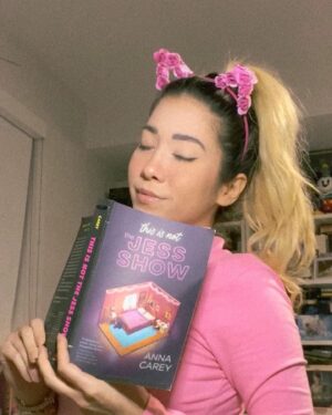 Michelle Grondine Instagram - Q: if you could live in any fictional world, which world would you live in, even if you knew you might not be able to return to your own reality? 

HAPPY BOOK BIRTHDAY TO ✨𝑡ℎ𝑖𝑠 𝑖𝑠 𝑛𝑜𝑡 𝑡ℎ𝑒 𝕁𝔼𝕊𝕊 𝕊ℍ𝕆𝕎✨ by @annacareybooks !!!!!!! which is out from @quirkbooks ᴛᴏᴅᴀʏ 🥳🎉

i am currently in the thick of this book—a Black Mirror meets My So-Called Life with maj YA The Truman Show vibes—and loving every second. i will not disclose whether i am reading slowly because i am trying to make this world last for me (does anyone else do this???)

when this Ithaca College alumni saw the main character, Jess, was simping over a thrifted tee that upstate new yorkers will know dearly and love, i knew i was in for a treat.

jess’s voice is charismatic, inviting, and engaging, and i feel like i’m hanging out with one of my best friends when i’m reading along, which is one of my favorite feelings to experience when i’m reading.

i’ve recently come to the realization that stories that examine the gap between fiction and reality are the stories i gravitate toward the most. 

two of my most recent fav kdramas—W and extra-ordinary you—are both about the line between reality and the manhwa world.

if you are like me, and you love stories that ruminate the line between fiction and reality, This Is Not the Jess Show is for you. 

further, i have an 110-film (at present) letterboxd list titled, “what is reality?” comprised of films that i have watched which are meditations, ruminations, and explorations on the nature of reality and existence. find me @tediously_brief or click the linktree in my bio for a link to the curated film list :))

could be more excited for everyone to also finally get to read This Is Not The Jess Show !!! peep the comments for the full synopsis of the book!