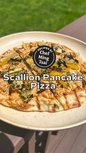 Ming Tsai Instagram - Scallion pancakes are fantastic for many things, one of them being a delicious twist on pizza! 🍕⁠
⁠
Ingredients⁠
1 package Scallion Pancakes, found frozen at Asian markets⁠
1 bell pepper, cut into 1 ½ inch pieces⁠
½ onion, cut into 1 ½ inch pieces⁠
1 portobello mushroom⁠
1 zucchini, cut lengthwise into ¼ inch slices ⁠
Coconut spray⁠
Kosher salt and freshly ground black pepper⁠
Skewers, soaked for 1 hour in water⁠
⁠
Instructions⁠
1) Carefully spray your grill with coconut spray and add scallion pancakes. Flip your pancakes once they have grill marks and are GBD. Remove when both sides are crispy. ⁠
2) In the meantime, skewer your onion and bell pepper pieces. Spray all your vegetables with coconut spray and season with S&P. Add to grill and close the lid, Grill about 2-3 minutes on each side. ⁠
3) Remove vegetables from the grill, roughly chop them and mix together. ⁠
4) To build your pizzas, spread ¼ cup tzatziki on each pancake and top with your mixed vegetables. Cut into slices. Enjoy! ⁠
⁠
⁠
Tzatziki: Ingredient List⁠
1 cup greek yogurt ⁠
1 tsp garlic, minced⁠
1 tsp ginger, minced ⁠
1 tbsp scallion greens, sliced⁠
¼ cup cilantro, roughly chopped ⁠
¼ cup thai basil, roughly chopped⁠
2-3 tbsp chili crisp, plus or minus depending on your spice preference⁠
⁠
Tzatziki: Instructions⁠
In a bowl, mix all ingredients together. Adjust spice level by adding more chili crisp. Serve on Scallion Pancake Pizza. Enjoy! ⁠
⁠
🌟 Make sure to SAVE this recipe to make later! 🌟⁠

#scallionpancake #asianfood #grillingrecipes