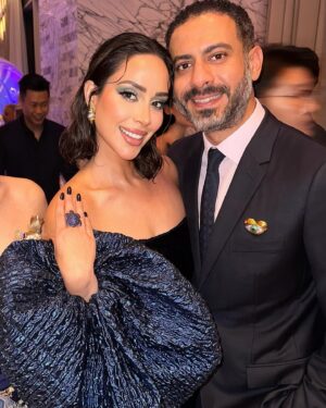 Mohamed Faraag Instagram - He’s the Prince Charming to this Mermaid 🧜🏻‍♀️🧿

We had a ball at the Vogue Ball ✨

Thank you @voguearabia @mrarnaut for having us 🫶🏼

Look curated by @dimaayad 
HER 
  Dress @dimaayad 
  Jewelry @begumkhan 
  Shoes @prada 
  Makeup @rehamkhalifaa @charlottetilburyarabia 
  Hair @rosannagracehair 
 

HIM
  Full look @dior 
  Brooch @begumkhan 

PR @daccomms 
📸 @dazlproduction