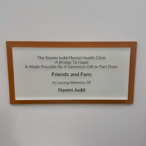 Naomi Judd Instagram - Naomi’s husband, Larry Strickland recently visited Mercy Community Healthcare’s “Naomi Judd Mental Health Clinic: A Bridge to Hope.” The Naomi Judd Estate is honored to pair with the team at Mercy. 
A portion of proceeds from the collectibles available May 1 & from all forthcoming archive collections at NaomiJuddLegacy.com will go to “A Bridge to Hope.” 🤍 
Just a reminder this is a healthcare facility. While we are so happy to have the fans be a part of this initiative through NJL, out of the respect of their patients, please remember this is not a tourist destination. Thank you. 🙏🏼 
~ Mercy Community Healthcare offers comprehensive primary and mental healthcare to adults and children. Mercy exists to reflect the love and compassion of Jesus Christ by providing excellent healthcare to ALL and support to their families. ~