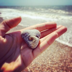 Natalie Gumede Instagram - It caught my eye amongst millions
This stone with a swirl at its heart
Its form of love, with a crashing wave
Mirrors the ways I want life to restart

Perhaps its imprint is from a shell?
Edges surely, smoothed by the sea?
A lesson - as I emerge from a personal hell
Of how we are meant to be

Yielding, morphing, staying strong 
Nature won’t assign these emotion
From the years a pebble is broken down
It eventually becomes the ocean

I felt the breaking, yet drowned by the waves
In a vast beach I tried to hide
But this rock sat proud, with its perfect flaws
Asking ‘when will YOU turn the tide?’ My shape isn’t perfect, my edges still rough
Sea spray tastes the same as my tears
But sharpness can soften; I know I’m enough
And our love can stand out from fear

It’s good for ego to remember 
We’re naught but a grain of sand
But sometimes we need the reminder
The soul has bigger things planned

Pebble Heart holds the answer
To sensing the storms of the sea
‘When you feel small compared to the ocean
See the ocean is also in me.’ 24/05/20 - Thanks Pebble Heart!

Sometimes I write poems to make sense of how I feel. I rarely share them. And if I do, only with a few people. I saw this pebble today. And I decided to be brave 💙💛💙💛💙💛💙💛💙💛💙💛💙
#poetry #poems #healing #selfhelp #wellness #mentalhealth