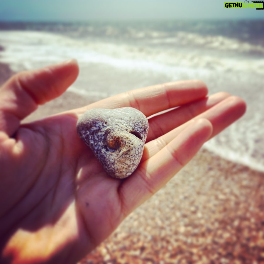 Natalie Gumede - 564 Likes - It caught my eye amongst millions
This stone with a swirl at its heart
Its form of love, with a crashing wave
Mirrors the ways I want life to restart
Perhaps its imprint is from a shell?
Edges surely, smoothed by the sea?
A lesson - as I emerge from a personal hell
Of how we are meant to be
Yielding, morphing, staying strong
Nature won’t assign these emotion
From the years a pebble is broken down
It eventually becomes the ocean
I felt the breaking, yet drowned by the waves
In a vast beach I tried to hide
But this rock sat proud, with its perfect flaws
Asking ‘when will YOU turn the tide?’ My shape isn’t perfect, my edges still rough
Sea spray tastes the same as my tears
But sharpness can soften; I know I’m enough
And our love can stand out from fear
It’s good for ego to remember
We’re naught but a grain of sand
But sometimes we need the reminder
The soul has bigger things planned
Pebble Heart holds the answer
To sensing the storms of the sea
‘When you feel small compared to the ocean
See the ocean is also in me.’ 24/05/20 - Thanks Pebble Heart!
Sometimes I write poems to make sense of how I feel. I rarely share them. And if I do, only with a few people. I saw this pebble today. And I decided to be brave 💙💛💙💛💙💛💙💛💙💛💙💛💙
#poetry #poems #healing #selfhelp #wellness #mentalhealth