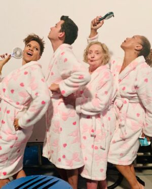 Natalie Gumede Instagram - Merry Christmas Everyone! Hope you’ve all had the kind of day that suits you 🥳here’s some BTS shots of #yourchristmasormine 
1. Dressing gown gang (with fans for me and @theangelagriffin because - fleecy dressing gowns in July🥵)
2. Kaye’s boots that you never saw in shot but I LIVED for
3. Nails that I thought looked good that long  when I went to the salon but I couldn’t do DAMN THING WITH (I’m not a nails person)
4. UK JULY SNOW! 🤩
5. End of shoot applause for the incredible #JuneWatson 
6. Fabulous makeup and hair designer @emilybilverstone1 making me pretty
7. Bonus shot of the ice cream van in my stories😜
@primevideouk