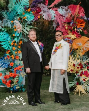 Nico Santos Instagram - Ok reposting coz some pics weren’t showing up…Wanted to share some more images that our incredible photographer @logancolephoto captured on the big day...  

My husband @zekerchief is the cutest 😍😍😍
  
A lot of y'all have been asking about my wedding look so here's the breakdown:   
  
Boutonnière: @cobralily of course! I wanted a statement and I got it!   
  
Frames: custom made by @romainkayo_eyewear! They have these lovely brass magnetic purple ombré sunglass lenses that I made good use of when the sun was blaring..  
  
Jacket: @driesvannoten that I got online for like 80% off. I've had my eye on this jacket forever (she loves a good deal henny!) but chose it because the shoulders was giving slight Filipiniana Terno vibes.   
  
Barong/Pants: custom made by the amazing @veejayfloresca! I knew I wanted an extra long barong because I wanted it to evoke bridal. And wide leg pants coz that's all I'm wearing nowadays lol   
  
Shoes: @paulsmithdesign, the first pair of tux shoes I ever bought years ago!   
  
  
But also LOOK AT THESE FIERCE QUEENS!!! @justjolopez @nebuyaystyles and @aianashaw gave us EVERYTHING and made the night even more memorable. 

🩷❤️🧡💛💚🩵💙💜🤎🖤