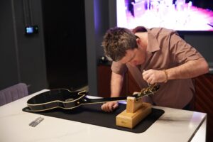 Noel Gallagher Instagram - In celebration of the grand opening of the #GibsonGarageLondon, Noel has partnered with @gibsonguitaruk to release 20 signed Gibson ’78 Les Paul Custom guitars.

The Noel Gallagher ’78 Les Paul Custom will only be available in-person on the official opening day of the new flagship store on Saturday 24 February 2024.

All profit from the sales of this special run of guitars will go to support the Teenage Cancer Trust.

Inspired by the guitar originally given to Noel by Johnny Marr and used extensively for both live performances and recording sessions with Oasis, these ’78 Les Paul Custom guitars feature a lightly aged Ebony finish by the Gibson Custom Murphy Lab, and each guitar is hand-signed by Noel.