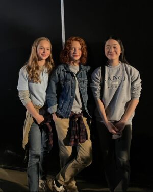 Olivea Morton Instagram - Here is the picture of myself and Uncle Rick that I mentioned in the interview with #EntertainmentRoadmap.  There is also a rehearsal for the fountain stunt where Cassandra is standing in for Walker.  It was my first wirework experience, and now I know how it feels I really want to do more stunts!

The entire crew made sure we were all safe and comfortable at all times.  I had a wetsuit on underneath my wardrobe, and was given all the hot tea, towels and blankets that I needed.  Even my trailer had a fireplace that kept everything nice and cozy!

I’m really happy that they decided to make Nancy and her friends pretty rather than how Percy describes us in the book, even though I was totally up for it!  But if you think about it, it’s written from a twelve year old boy’s perspective, and it makes sense.

Thank you to everyone who has watched the entire interview, I am a talker!  You have given me such wonderful compliments, and it means the world to me!  The entire time was a fantastical experience, one that I will cherish my entire life. 🔱🧡🩵

#rickriordan #nancybobofit #percyjacksonandtheolympians