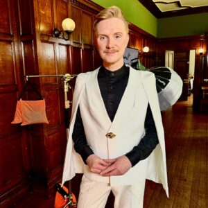 Owain Wyn Evans Instagram - Wanna feel fancy? Wear a cape suit! I saw Michelle Yeoh wearing this sen-sat-ional outfit on The Brothers Sun and the look inspired me to trawl the depths of the web to find something similar and self-style! ✨(I was also compared to Princess Leia and Count Dracula during filming, which quite frankly I’ll take as compliments 💅🏻 😂) Jaw dropping homes for you to see on our new series of Wales’ Home of the Year - coming soon to BBC One and iPlayer!