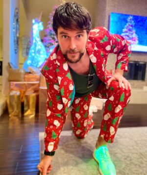 Owain Yeoman Instagram - Dressed in my Christmas Best! As you can see we take Christmas very seriously in our house!! And yes the shoes are neon LED. Only sad you can’t see the other one in red!! After a strange 2020 I want to wish all of you lovely folks a happy, healthy, bright and optimistic 2021. Let’s never take for granted the simple pleasure of being able to hang out with the ones we love! Whatever you may celebrate and whoever you are with this year I wish you and your families the safest, happiest and most fun filled holidays! With huge love from Me, Gigi, Everbelle and Phoenix X #dresstoimpress #christmas #xmas2020 #merrychristmas #happyholidays #holiday #christmassuit #peaceandlove #family #love #holidayseason #holidays #happy #whatarethose #santasuit #christmas2020 #lit #shoes #fancydress #christmastree #christmascracker