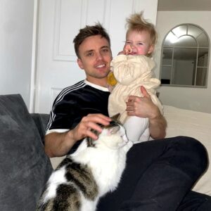 Parry Glasspool Instagram - Who said men can't multitask? No, really. Who said that? Who f*cking said that? We might never know. What I do know is that I never set out to be a  rolemodel - people who know me know that I did set out to be a hand model, but it made me nervous and I got sweaty palms, a big no-no within the industry. But as i said, I never wanted to be a role model, but here I am apparently breaking boundaries. Holding my firstborn and petting my feline. That's two different things, at the same time. I am a man. I can multitask. This is the new world. Thank you.