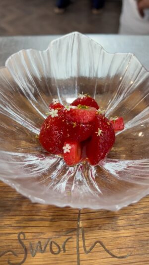 Paul Ainsworth Instagram - Gariguette Strawberries 🍓
These stunning, early summer strawberries from Breton, are renowned for their aromatic, sweet, but equally tangy flavour, and their fondant like texture. The perfect strawberries to see us through until, in the coming weeks, they’re available more locally. 

We serve the strawberries two ways, firstly, just brushed in olive oil and studded with roasted Sicilian pistachios. Secondly, macerated in jus de fraise, which we make from Sauternes, the remaining strawberry trim, hibiscus, and a sprinkling of verbena pepper. We reduce everything down, using this liquor to re glaze the strawberries, before serving atop a warm rhubarb purée, which we make using Robert Tomlinson’s outdoor Yorkshire rhubarb. We finish this with elderflowers, fennel pollen and a granita made from the remaining Jus de fraise. 

We serve this alongside two accompaniments. Our signature roasted vanilla gelato, drizzled with the brilliantly intense Provençal Moulin de Cornille olive oil, and our rich, floral Leatherwood Honey Madeleine’s made with salted brown butter and a grating of arabica coffee.