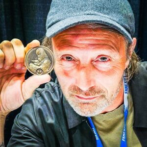 Peter Mayhew Instagram - ENCODED MESSAGE: Password ‘Stardust’ Galen Erso is urging you to HELP THE WOOKIEE GIVE!  Get your charity challenge coin or patch at the link in our bio!

Much love to Mads Mikkelsen! @theofficialmads
