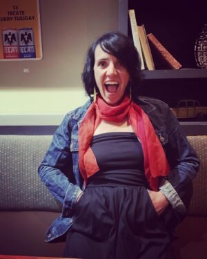 Quinn Brett Instagram - A paralyzed girl walks into a bar…… 
#riddlemethis 

And after parking her wheelchair in a booth in the middle of a series of booths, transfers to sit her bum into the cushy bench seat.  Empty wheelchair in still navigable aisle.  There are 8-10 patrons sitting at the bar proper. The 6-8 booths are now all full and the 4 high top bar tables in between the bar and booths all unoccupied with 3 bar stools per table strewn around the tables disorganized. A waitress approached, “this can’t stay here (pointing to my legs aka wheelchair), it’s a fire hazard”. 

“Huh” I said taken off guard. “Then this establishment should be more accessible”. I mumbled. She retorted, clearly in a heightened state. #notlistening 

I reflect now and could have communicated more clearly, not matching her defensiveness. 

Today, The sassy part of me arrived and wishing to say…. “Okay, so your going to remove the paralyzed girls ‘legs’ to a back nook of the bar. And when the ‘raging 🔥 fire’ hits, as everyone rushes out of the building the two options for me are  1.) sit and pray? 🤭
2.) my date fights his way upstream to find my chair— ??— then flows seamlessly back to me and we both escape unscathed. 🧚‍♀️ 

Neither option makes reasonable sense. 

This is my first encounter with this type of miseducation and “rule” following in a pub. Of course I have experienced this shit on airlines and on trail. It’s maddening because it happens to my community over and over again.  This is small potatoes but an example of the day-to-day constant 💩 

We left the bar. It was easier. But I am tired of leaving the bar, shrugging as the TSA agent takes 40 minutes to get to me and pat me down —-#areyougoingtoinsertthatcatheter. ?? 

More so it’s demoralizing to feel like I am in the wrong for requesting simple dignity, respect and credibility.

The joke #thework is unfortunately left to the minority to motivate to speak up, to fight. A helpful solution would Be if the majority could  do better to educate ourselves and try harder to close the gap between responsibility and complacency. 

 #tired #respect #IllBeYourFireHazard

Image- brunette woman looks enthused, eyes open and mouth open as she sits.
