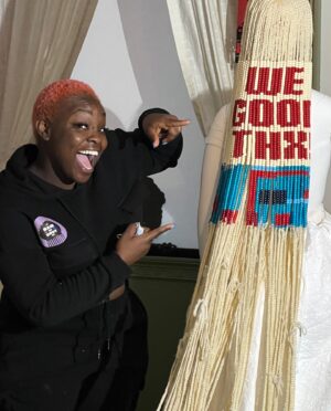 Radha Blank Instagram - #wegoodthx!
By Radha Blank

OPENS TODAY!

@metmuseum @metcostumeinstitute for #metinamerica 

My first foray into the fine arts world that aims to insert the often uncredited unseen and erased #blackwoman aka the “muslin” aka the foundation of American culture in spaces where our contributions have been discarded.

Just want to thank some key artisans who helped to make this happen!

@elizabethcolomba who’s amazing renderings of my room helped fortify my vision. This is just her first sketch. The final illustration you shall see is breathtaking! Also crafting my gorgeously haunting black cherubs in a pinch! 

@peterkimpeterkim my producer who always fought to get me what I needed to take this concept out of my head and into the #haverhill room as a reality. 

@denise.trotman who created a daggon bead grid graphic out this piece! A literal map for the #wegoodthx! bead quilt in homage of #mariebendolph an 88 year old geesbend quilter. The beads are inspired by her “Work-clothes quilt” c. 2002.

Thank you @steffisees for your precision edit on the black women hands! 

#bradfordyoung you are my brother for life. So grateful we got to come together on this. Your input and brilliance took us to the next level. As did you golden eye @christianepps A dream to get to work with one of my heroes.

Eric Hirsch aka @sapesifter who in a last minute crunch mixed our lovely sound scape.

And Susy Oludele…aka @hairbysusy @africancreature. My Naija sis. I’m not just blown away by your talent and work ethic…it’s your heart sis. Every time I stepped into your shop, I could feel the love you have for your craft. Grateful to you and all the beautiful black women who danced and laughed as they birthed our daughter “Casandra” with love. Thank you @kellyaugustine for being a bridge. ❤️✊🏽

Thx @janicza for capturing Ms. Monae as she takes in #wegoodthx! Honored to share space with your genius!