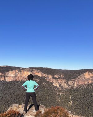 Rae Johnston Instagram - The sun and moon sharing the sky, sandstone paths, grass trees, huge ancient cliff faces, and that beautiful river flowing in the deep valley below 🤎 

Today’s walk on Wiradjuri, Darug & Gundungurra Country - making the most of the clear skies while they last, looking wet and below freezing next week! 

#bluemountains #rigbyhill #piercespass #wiradjuricountry #darugcountry #gundungurracountry