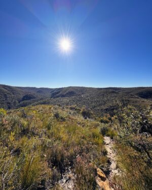 Rae Johnston Instagram - The sun and moon sharing the sky, sandstone paths, grass trees, huge ancient cliff faces, and that beautiful river flowing in the deep valley below 🤎 

Today’s walk on Wiradjuri, Darug & Gundungurra Country - making the most of the clear skies while they last, looking wet and below freezing next week! 

#bluemountains #rigbyhill #piercespass #wiradjuricountry #darugcountry #gundungurracountry
