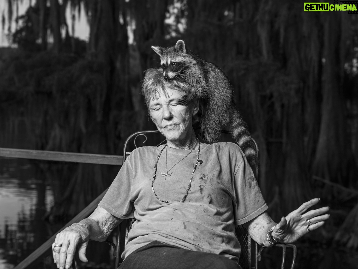 Robin de Puy - 0.9K Likes - New episode! #linkinbio
Caddo Lake is as smooth as a mirror’s surface and filled with large yellow flowers proudly reaching for the sun. “When the flower has finished blooming, the fruit remains, '' says Chaz (38), born and raised in Uncertain, a small village bordering the lake. He picks up a ripe piece of fruit: “Here, have you ever tasted this?” Without hesitation, I bite into the sweet seeds of the American lotus.
Uncertain is on the border of Texas and Louisiana. It has 85 inhabitants and is buried deep in swampland. Large moss-covered cypress trees give the village a somewhat ghostly appearance. The town is perfect for anyone who does not want to be found. People take care of their own business here and help from outsiders is not welcomed.
“The lake raised me. I am a real swamp-rat.” Chaz's beard blows gently in the wind. “We have everything we need here: water, food, and medicine. Life doesn't come from a store. It starts in nature.” It sounds like paradise, and I would rather not leave.
When I ask Chaz who I should definitely meet here, he immediately replies, “Dottie! She used to be my teacher and she's the SuperWoman from Uncertain.”
Before long, I found her. Dottie is 83 years old and still likes to ride her Harley Davidson, sometimes with a cape - she is SuperWoman, after all. She clearly loves life as well as her raccoon, Willow, who is always perched on her neck or in her lap.
Dottie owns a lot of land, including a small graveyard. “Always wanted one.” It came in handy when her husband Billy passed away last year. Wrapped up with cloth, he was six feet under within twelve hours. He thought he was dying of an infection because he had given a baby raccoon mouth-to-mouth, but Dottie disagrees.
“The average age of an Uncertainer is only 58. Fresh vegetables are hard to find here. And almost all of the food is deep-fried. Combined with frequent use of alcohol and cigarettes, it doesn't appear to be the best way to grow old. And then there's something about mercury in the water.”
Mouths full of American lotus seeds and acclaimed scenery, yet it’s less like paradise after all. As it turns out: nothing is certain in Uncertain.