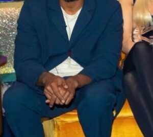 Romesh Ranganathan Instagram - I’m on Jonathan Ross tomorrow night on @itv at 10.15pm I think. It’s a great line up but the star of the show was the button I forgot to undo that spent the night struggling like Spiderman trying to hold that ship together.