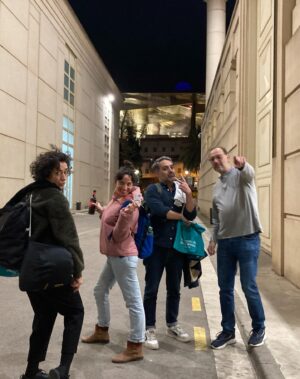 Sara Barros Leitão Instagram - Memórias de uma viagem a Barcelona para encenar uma leitura de um texto que escrevi para o Teatro Nacional da Catalunha. 

Este ano, foi Portugal o país escolhido pelo Teatro Nacional da Catalunha para se apresentar na Dramaturgia Emergente Europeia. Passei uma semana em Barcelona, guiada pela mão conhecedora do Manuel Tur, que encenou uma leitura do texto da Joana Craveiro, "Viagem a Portugal", enquanto eu encenava uma leitura do texto que escrevi propositadamente para este momento, "Regras para um beijo". É difícil descrever o quão bem recebidos fomos. Tínhamos um palco e uma equipa à nossa espera, e pudemos criar as leituras à escala do que éramos capazes de imaginar. Não fomos comedidos no amor que entregámos aos nossos atores, que confiaram em nós, na nossa direção e, no meu caso, que gentilmente me ofereceram a oportunidade de ouvir pela primeira vez o meu texto nas vozes de outros. Assim como entregámos parte do nosso coração e da nossa gratidão a toda a equipa que nos acolheu, que nos escutou, que assistiu atentamente a todos os ensaios, que imaginou soluções e antecipou problemas. O companheirismo, dedicação e rigor do Adrià Pinar foi essencial. Entrou nas nossas cabeças e transformou em luz, som e cenário a forma das nossas ideias. 

A par disso, há mais uma coleção de fotografias que não partilho aqui, mas que me acompanharão na memória de uma viagem maravilhosa. Visitámos a Sala Beckett, vimos um espetáculo brilhante no Teatre Lliure, comemos muito Ramen, batatas bravas e anchovas, vimos uma exposição sobre o SAAL e sobre processos semelhantes em Espanha e Itália nos pós-didaturas, caminhámos muito, fomos legalmente assaltados quando descobrimos o preço do brunch que acabáramos de comer, comprámos livros de teatro, conversámos sobre teatro e sobre a vida, aprendi palavras em catalão e ensinei palavras em português.

E tive muita sorte de poder partilhar toda esta experiência com o Manel, com quem aprendi sem que ele soubesse, enquanto o via a trabalhar, a encenar, a dirigir e a criar. 

O meu texto imaginava o que os fantasmas faziam nos teatros vazios. Mas é mesmo bom quando podemos chateá-los e preencher os teatros de pessoas e ideias.