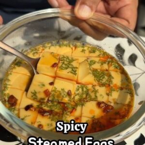 Saransh Goila Instagram - Under 15 mins you can make these eggcellent recipe. When you'll eat these spicy steamed eggs it's like eating clouds. They're air light and oh so delishaaas. Will you try this at home?
.
.
Steamed Eggs 

Look at that 😮‍💨🤌🏻
Crack 3 eggs 
145ml Vegetable stock 
Crushed black pepper 
1/4 tsp Red chili powder 
Salt to taste 
Whisk well 
Strain the mixture 
Add chopped coriander 
Cover with cling wrap 
& steam for 10 minutes 
over medium heat 
Once done let it rest for 5 minutes 
& then unwrap 

Cut the eggs as you like 
Top it off with soy sauce 
Chili oil 

Delishaaas 🤌🏻🔥