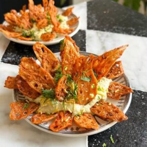 Saransh Goila Instagram - Easily the best chip and dip you can serve at your Holi party soon🥳 Kamal Kakdi - nadru - bhain - Lotus stem - this beautiful ingredient has many names but it's just Delishaaas no matter how you cook it! I will always choose this over any potato chips. Thank you @convinoboard for the plating inspo we made your blooming cheese into blooming dahi 😆
.
.
Kamal kakdi ki Chaat 

Peel & slice 2 Lotus stem 
Wash them well 
Look at that 😮‍💨🤤
1/4 cup Rice flour 
1/2 tsp Ajwain 
1 tsp Red chili powder 
Salt to taste 
1/4 tsp Garam masala powder 
1/2 tsp Jeera powder 
Toss them well 
1 cup Hung curd 
1/2 tsp Red chili powder 
Salt to taste 
1/4 tsp Black salt 
1/2 tsp Jeera powder 
2 tbsp Green chutney 
2 tbsp Imli chutney 
Mix well 
Frye the lotus stem in hot oil 
Till GBC 🔥🤤
Add a spoonful of the dahi chutney 
Place the lotus stem chips 
Delishaaas 😮‍💨🤤