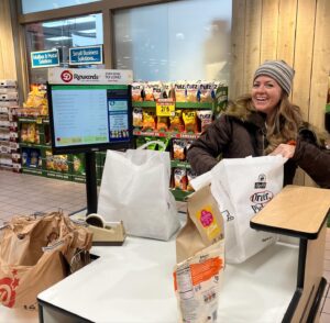 Seamus Dever Instagram - My adorable wife @cleverdeverwherever and I just went on a road trip with our dogs for a whole month. Here she recreates her old job as a bagger at Dierbergs. So good they offered her a job. Still got it. Isn’t she just adorable?