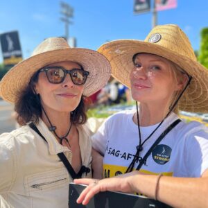 Tara Buck Instagram - Stay unified ✊ Bright side of strike☀️ marching alongside friends and colleagues, bumping hat brims and sharing sunscreen.  Our spirits are high and our determination is unwavering.  Here with the brilliant @iammichelleforbes on the line.  Friend, you are as solid as a rock. #sagaftrastrong #sagaftrastrike #unionstrong @sagaftra