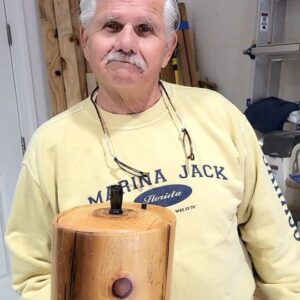 Tom Silva Instagram - This project challenged me the whole way but I think it turned out pretty great in the end. What do you think?

I always try to make a gift for the homeowners when we complete a This Old House project. This piece a gift for the #thisoldhouseipswich homeowners.

I started with an old 8x8 carrying beam that was removed from the home during the renovation. I had the idea to turn it into a lidded container that they could use and display in their kitchen.

The beam had some significant cracks that I filled with a black putty epoxy to keep it from breaking apart and to add some visual interest to the finished piece. Once the epoxy dried I added extra support by taping around the circumference of the piece. 

This was a tricky project because I only had my mini lathe and limited tools available. The hollowing out process was particularly challenging — getting a tool in deep enough to tackle the end grain. It flew off the lathe a couple times while I was working on it so I decided to remove a portion of the top to make it a little shallower and easier to access.  

I used a hand saw because I didn’t want the top edge to be square/straight. I thought it would be interesting for the lid to sit level on the inside lip of the container while the top edge was irregular.  

I turned the lid from a piece of the old flooring board that I believe was pumpkin pine. The knob for the lid was turned from a scrap piece of purple heart I had on hand.