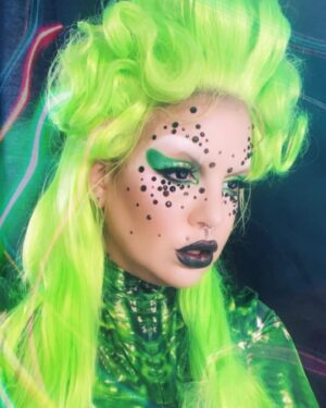 Yvonne MacInnis Instagram - I’ve been wig styling a bit more these days.. getting closer to my final form👽

Makeup Details: 

🧚🏼 @patmcgrathreal foundation 
🧚🏼 @kevynaucoin contour & Highlight palette
🧚🏼 @yslbeauty concealer 
🧚🏼 @kevynaucoin loose setting powder
🧚🏼 @kimchichicbeauty white concealer
🧚🏼 @anastasiabeverlyhills X @alyssaedwards_1 eyeshadow palette 
🧚🏼 @thecreativemakeup duochrome color shifting pigment
🧚🏼 @nyxcosmetics matte liquid liner
🧚🏼 @itcosmetics mascara 
🧚🏼 @thecreativemakeup 12 cream color palette 
🧚🏼 @thecreativemakeup 12 cream color palette & Neon Paint   line kit in UV GREEN
🧚🏼 @francisstarcosmetics brushes 
🧚🏼 @danessa_myricks color fix   twin flames liquid eyeshadow 
🧚🏼 @cozzettebeauty foil shadows 
Body suit @candy_catz_wear 💚👽⚡️

#makeupartist #stylist #creative #drag #wigs #wigstyling #neonmakeup #uvmakeup