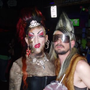Acid Betty Instagram - I met a guy at every @misssherryvine show who quickly became one of my dearest and best friends. I'll never forget the day I saw his faux hawk, and I thought to myself, 'I want to wear that and dress up with you next week.' That moment marked the beginning of what is now known as Acid Betty (there’s a photo him putting me in his first hawk piece, I was LIVING!).

Marec was not only my personal hairdresser but also my closest friend and the ultimate party companion. He taught me everything I know about hair and is the creator of my signature mohawk and wiglets, as I fondly call them.

Getting older has its challenges, but perhaps the toughest part is losing the friends and companions who have been with us through the years. I used to take photos like crazy before cameras were part of our phones (haha), and I've dug up some early snapshots of us. Those were the days when we'd experiment with hair and makeup and parade around the clubs like a couple of wild fools!

Marec, I miss you more than words can express. You will always be in my heart, and I'll forever cherish the memories we created together. I love you, Acid Sharek!