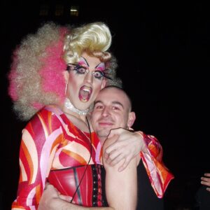 Acid Betty Instagram - I met a guy at every @misssherryvine show who quickly became one of my dearest and best friends. I'll never forget the day I saw his faux hawk, and I thought to myself, 'I want to wear that and dress up with you next week.' That moment marked the beginning of what is now known as Acid Betty (there’s a photo him putting me in his first hawk piece, I was LIVING!).

Marec was not only my personal hairdresser but also my closest friend and the ultimate party companion. He taught me everything I know about hair and is the creator of my signature mohawk and wiglets, as I fondly call them.

Getting older has its challenges, but perhaps the toughest part is losing the friends and companions who have been with us through the years. I used to take photos like crazy before cameras were part of our phones (haha), and I've dug up some early snapshots of us. Those were the days when we'd experiment with hair and makeup and parade around the clubs like a couple of wild fools!

Marec, I miss you more than words can express. You will always be in my heart, and I'll forever cherish the memories we created together. I love you, Acid Sharek!
