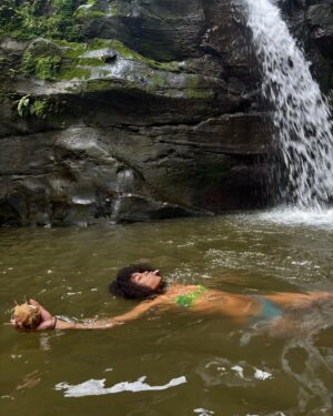 Ajani Russell Instagram - Bliss is truly just eating a coconut you opened with only your hands under a waterfall.

I went on a very special retreat with @theintuitionschool.co last month. I attended as a cohost and a teacher but I learned so much on this trip I might as well have been a student. So many lessons and experience that will never  be articulated because the land doesn’t speak english. This particular day at the waterfall I released something that no longer served me, I saw many lil frogs and I learned how to crack open a coconut on a rock (El saw me do this and said ‘damn you’re carribean af’ 😂) I reconnected with myself and my roots in ways I didn’t know I wanted but definitely needed. The first of many Costa Rica photo dumps. Can’t wait to share the rest with y’all. 🫶🏾