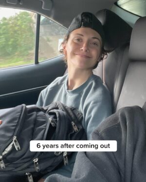 Alyson Stoner Instagram - Straight ppl will think it’s a glow-down 🤞🏻🌈 

Alt text: First slide is Alyson standing on a red carpet, wearing a pink fuzzy skirt set with text overlay that reads “6 months after coming out”. Second slide is Alyson sitting in a car with shorter hair, and wearing backwards black hat and grey crew neck with text that reads “6 years after coming out”.