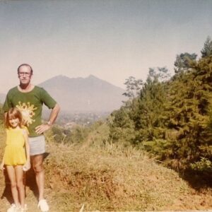 Angela Kinsey Instagram - I moved to Indonesia when I was two and lived there until I was fourteen. I loved living there and have always wanted to go back with my own family and I’m so thankful we finally got to go! I was pretty emotional when we landed. So many memories of my childhood, so many of which included my Dad. I wish we could have stayed longer but I’ll just have to go back! Here are some photos from our first stop… Sumba Island. 1. Our first day at @nihi . Such a beautiful place. Terima kasih to Doris and Maxy and all the folks there for taking such good care of us! We loved getting to know you all! 2. A vehicle that comes with coconut cup holders, yes please! 3. Evening walk at Nio Beach with my fella. 4. Oh hello… 🐉. 5. My favorite Kerupuk & Nasi Goreng! 6. Rua Beach. 7. Loved that we all watched the sunsets together! 8. Amazing pink bougainvillea (How did they shape it like this? I loved it! I think I took a picture of it every day. ) 9. Favorite hiking buddy. This was an hour and half trek so you know I got my steps in that day! 10. The color of the ocean is so beautiful. 11. Dad & me in Indonesia in the 70’s! 🩷 More of our trip in my next post. I took so many pictures!