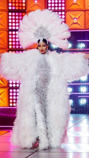 Angeria Paris VanMicheals Instagram - Category is “Bring back my pearls” and I’ve never felt more beautiful on that runway!! ✨

Gown: @vee.monique 
Coat and headpiece: @fantasyfeathersnyc 
Hair: @_hairwitch