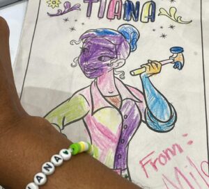 Anika Noni Rose Instagram - A wonderful day at @galaxyconraleigh! Thank you kind, beautiful people for all of the gifts you gave and the gifts you shared-sometimes all in one. 

Thank you to all of you who wore masks.

Thank you to every one of you who stopped by and shared your loving hearts with me. 

See you tomorrow!

Remember, if you have a mask, if you just want any to be cautious, if you THINK you don’t feel well, please mask up. If you KNOW you’re sick, consider staying home. These lungs can’t take a bout with the 🦠

Let’s keep each other safe out here! 
See you tomorrow for the panel!
💚👸🏽

1. @Raycayz, I got my sticker and I love it! Thank you!!
💚
2. Coloring from sweet baby Mila, and first friendship bracelet of the weekend 
💚
3. Gorgeous embroidery frog necklace from @natsnostalgicstitches
💚
4. Amazing Tiana art by @flocolores
💚
5. Some more gorgeous art, by sweet @artbyannae . Thank you for your beautiful talent and huge heart🥰

Thank all of you for a beautiful day!

Hair I love by @indiamhammond 
Onesie by @martinesdream 

#galaxyconraleigh #galxycon #princessTiana