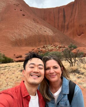 Benjamin Law Instagram - 24 HOURS IN ULUṞU

Shot this lil’ segment in beautiful Aṉangu Country after a rare evening of rain. It meant we could see the true black shade of the monolith under its red rust foundation, and how freshwater gathers at the base of the structure – which is taller than the Eiffel Tower, more ancient than the first dinosaurs and runs another 2.5km underneath.

Thanks to Uncle Sammy Wilson – son of Paddy Uluṟu! – for welcoming and handpicking bush tomatoes for us (an unexpectedly perfect mix of tomato and banana), and this dream team crew of the two Dans, Pariss, Bruno, Sarah and Toby. 

And, of course, icon Julia Zemiro who can do no wrong and for whom I would walk directly into peak hour traffic with my eyes closed if she asked. 

On yr TVs soon. Palya, peeps. ✌🏿✌️✌🏼